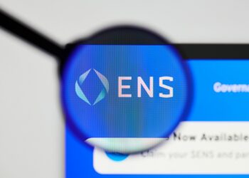 Milan, Italy - January 11, 2022: ethereum name service - ENS website's hp.  ethereum name service, ENS coin logo visible through a loope. Defi, ntf, cryptocurrency concepts illustrative editorial.