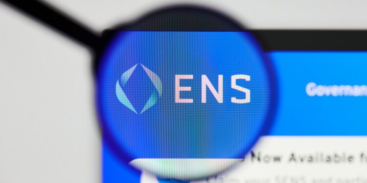 Milan, Italy - January 11, 2022: ethereum name service - ENS website's hp.  ethereum name service, ENS coin logo visible through a loope. Defi, ntf, cryptocurrency concepts illustrative editorial.