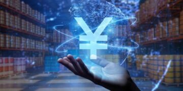 El símbolo del yuan suspendido en el aire sobre la mano de una persona.