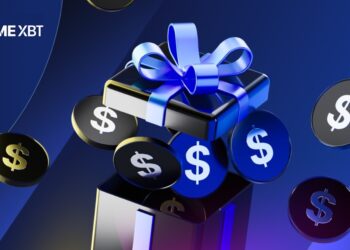 Caja de regalo con lazo azul y monedas con el símbolo $ alrededor.