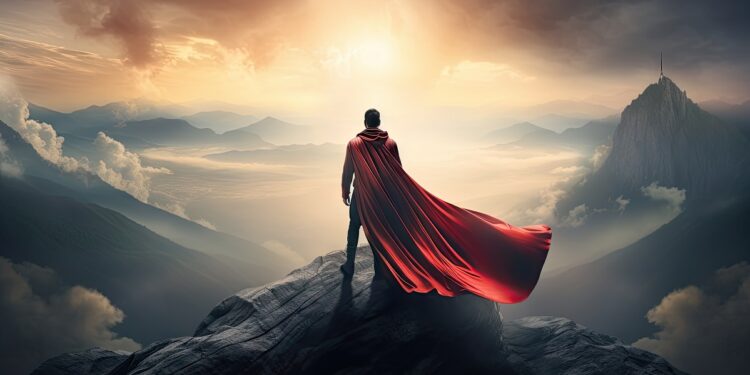 heroe con capa viendo al horizonte entre montañas