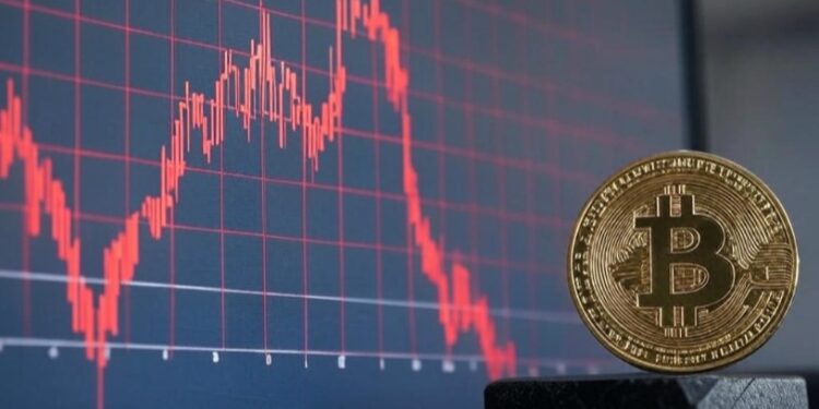 Gráfico de acciones en rojo y una moneda de bitcoin al lado