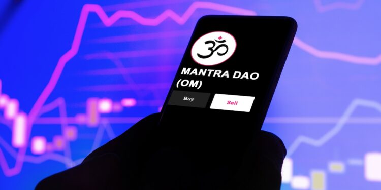 Un celular que se ve el logo del token mantra (OM).