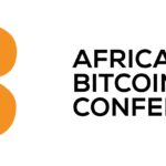 Logo de la conferencia Africa Bitcoin. Incluye el logo de Bitcoin en naranja con líneas que parecen rayos, ubicada a la izquierda. A la derecha, el texto 'AFRICA BITCOIN CONFERENCE' en letras negras mayúsculas.