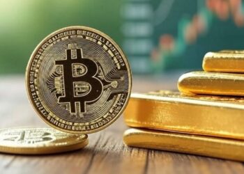Una moneda de bitcoin al lado de lingotes de oro y gráficas verdes en el fondo.
