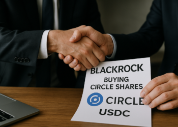 Dos hombres dándose un apretón de mano y uno de ellos tiene un contrato de compraventa de acciones.