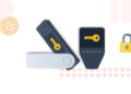 Dos dibujos de Hardware Wallet con una llave amarilla en ellas y una moneda de bitcoin y un candado amarillo a sus lados.