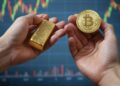 Una mano sosteniendo un bitcoin y otra pieza de oro.