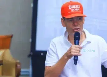 max keiser en un evento dando una charla