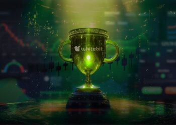 copa de premio con logo de whitebit sobre mesa con graficos de precio y de trading proyectados y difuminados en el fondo