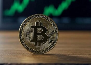 moneda de bitcoin con un gráfico de fondo