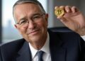 Ricardo Salinas sosteniendo un bitcoin.