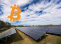 Un campo de paneles solares con el logo de bitcoin.