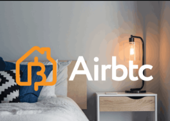 Un cuarto de hotel con el logo de la plataforma Airbtc, como Airbnb, pero con bitcoin.