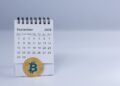 Moneda de bitcoin y calendario abierto en septiembre de 2025.