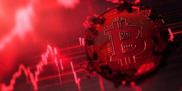Moneda de bitcoin en un gráfico teñido de rojo.