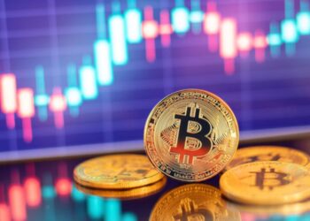 Bitcoin con gráficas de fondo.