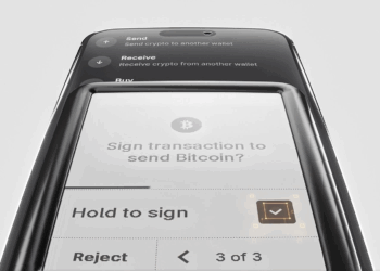 Ledger Nano™ Gen5 inclinada mostrando una pantalla en proceso de firma de una transaccion. Fondo blanco y marcos negros del hardware.