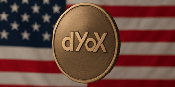 Moneda de dYdX en primer plano, con acabado metálico y de fondo, la bandera de Estados Unidos con sus franjas rojas y blancas y las estrellas sobre fondo azul.