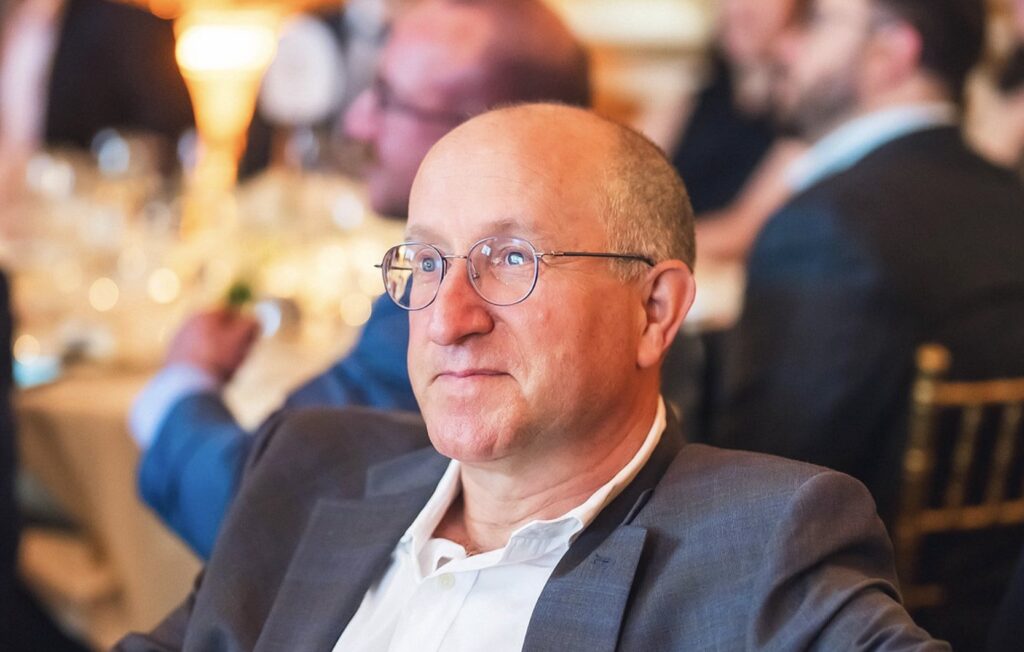 Eli Ben-Sasson at what appears to be a gala dinner looking diagonally at the camera.