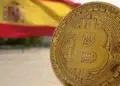 Logo de Bitcoin frente a una bandera de España.