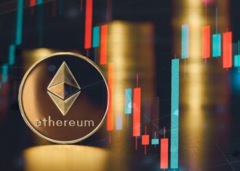 Una moneda dorada de Ethereum delante de un gráfico de precios.