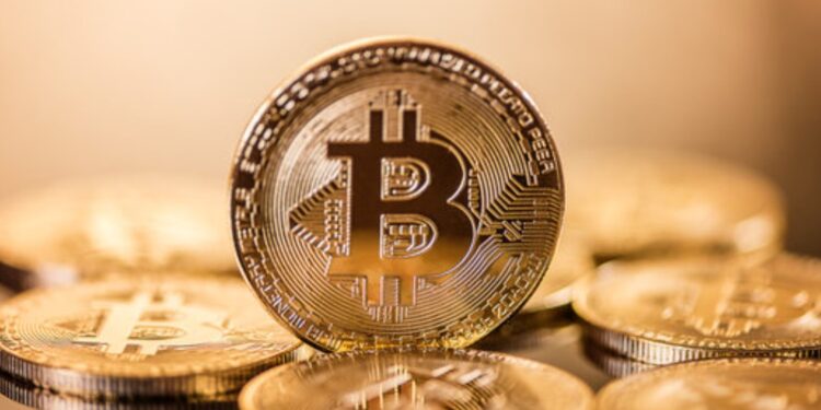 Monedas físicas de bitcoin doradas sobre un escritorio.