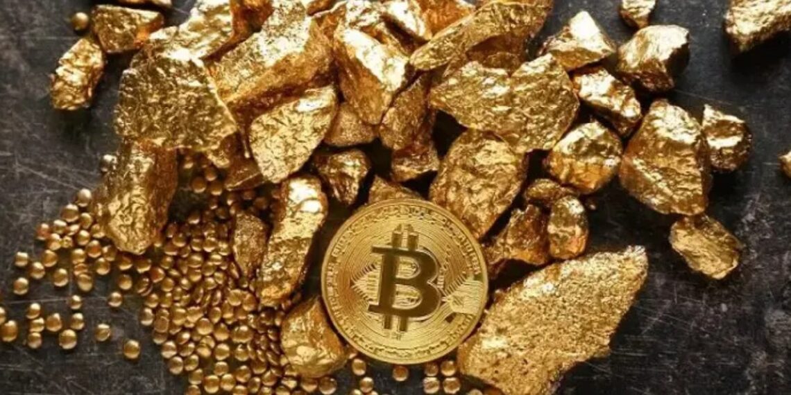 Una moneda física de bitcoin dorada rodeada de trozos de oro sobre una mesa.
