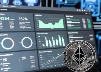 Una pantalla de una computadora con gráficos y datos financieros, junto a una moneda dorada de Ethereum.