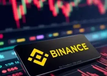 Membrete con el logo de binance frente a indicadores de mercados.