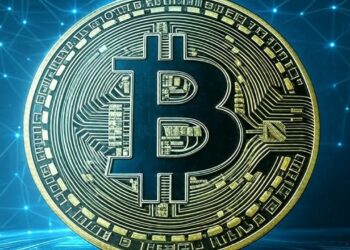 Logo de bitcoin delante de un fondo azul con puntos luminosos.