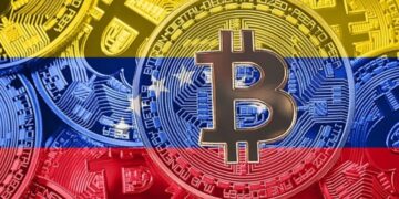 Monedas físicas de bitcoin con la bandera de Venezuela.