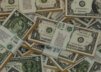 Fotografía de varios fajos de billetes de 1 dólar.