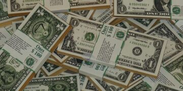 Fotografía de varios fajos de billetes de 1 dólar.