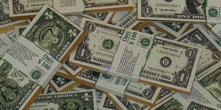Fotografía de varios fajos de billetes de 1 dólar.