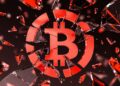 Logo de Bitcoin teñido en rojo y roto como si se tratara de un vidrio