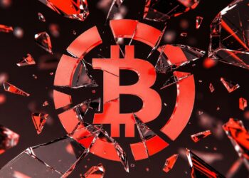 Logo de Bitcoin teñido en rojo y roto como si se tratara de un vidrio