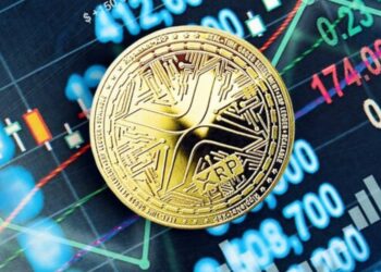 Moneda física de XRP sobre un panel electrónico.