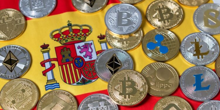 Muchas criptomonedas y detrás la bandera de España