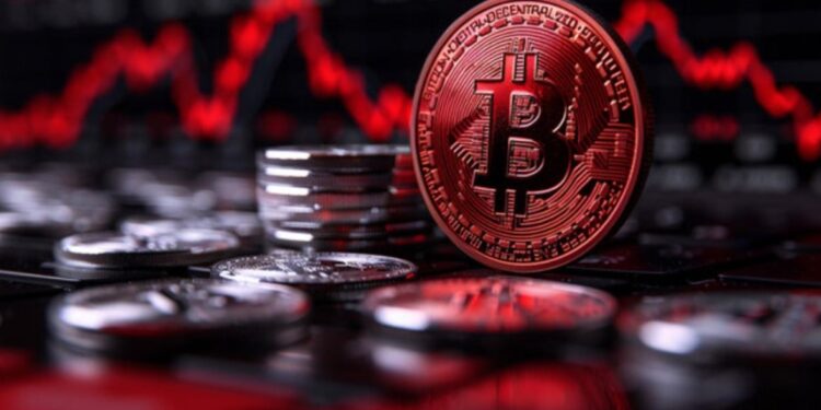 Moneda física de bitcoin dorada con otras monedas alrededor y gráficas en rojo.