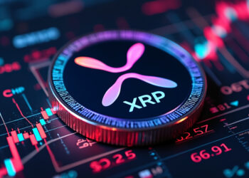 Una moneda física de XRP sobre gráficos de precio.