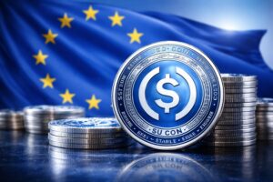 Monedas de la stablecoin USDC en primer plano con la bandera de la Uniรณn Europea desenfocada al fondo.