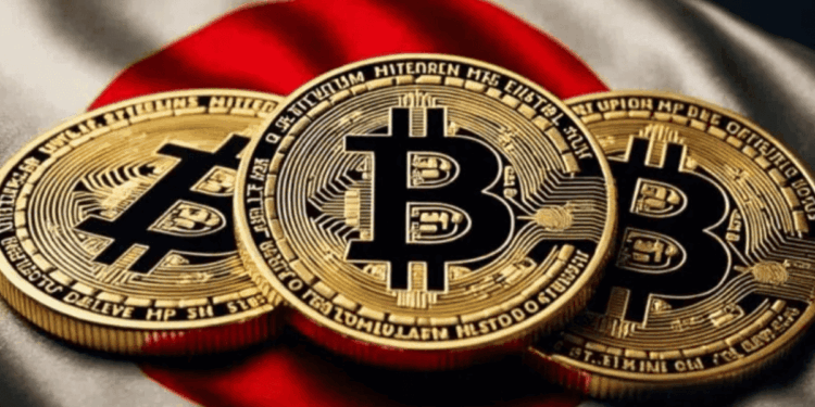 Tres monedas físicas de bitcoin doradas sobre una bandera de Japón.
