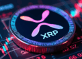 Una moneda física de XRP sobre gráficos de precio.