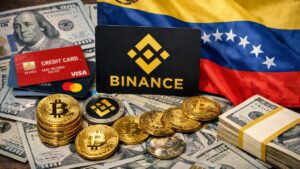 Monedas físicas de bitcoin, criptomonedas, con el logo de Binance, tarjetas bancarias y la bandera de Venezuela, así como dólares.