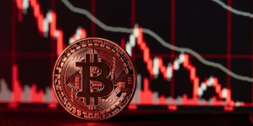 moneda de bitcoin y gráficos de precio en caída con luz roja