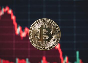 moneda de bitcoin y gráfico de precio en caída rojo.