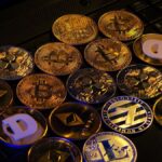 Muchas monedas físicas doradas sobre una mesa.