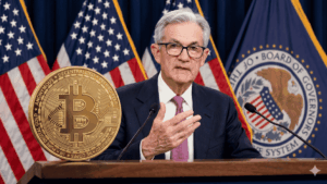 Jerome Powell hablando en un discurso, con una moneda física de bitcoin sobre su atril.