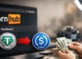 Pantalla de Pornhub mostrando transición de USDT a USDC para pagos a creadores.